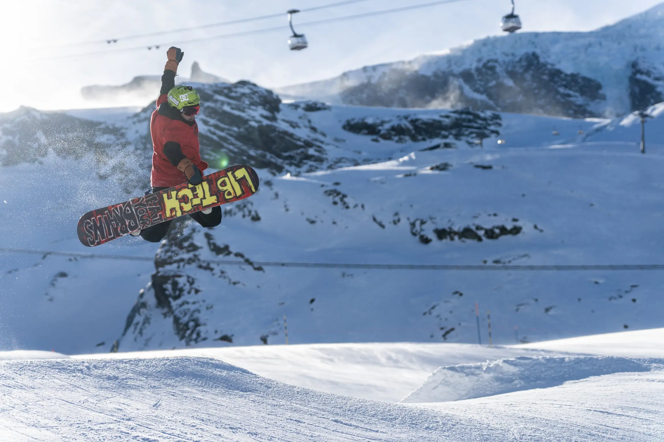 Snowboarder mid-jump in the snow park