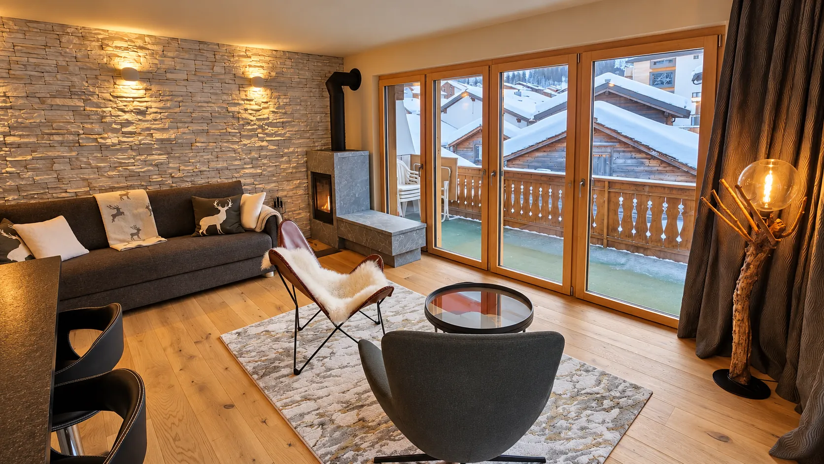 Living area with wood stove and stone wall in the Schmitta