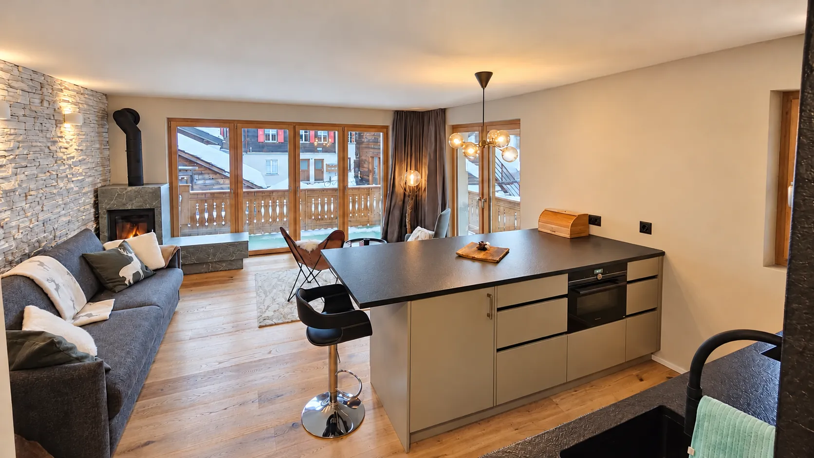 Living room with wood stove and stone wall